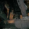 The remains of a second floor single plank wall and it's crown molding, nailed to the summer beam. Ceiling joists rest on the summer beam. (photo courtesy of Disaster One)