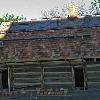 The tile is laid and allowed to run uneven over the rake boards ends as would have been done originally. Notice the scaffold is elevated so the tile can be layed without standing on the roof.