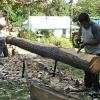 Skinning the log. Many of the original hewed logs have the bark left on.