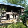 The pine log is lifted. This is a structural log, important to holding the house together.