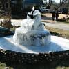 Ralph (George's neighbor) and Ann Hall (George's friend) admire Ralph's fountain, showing the effects of global warming.