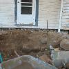 Old foundation rocks were found within the walls of a later porch.