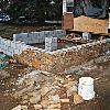 With the footings poured, the  block is laid and the rock is stacked.