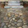 While the roof was being worked, the front steps were put in place. The rock work underpinning the porch is different, indicating a later period. Granite steps were typically used in the Greek Revival style.