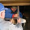 Ron Hash, electrician, helps with a beam cover. An exposed beam in the kitchen had been replaced, so we made a cover which matches the others.