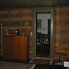 Looking from the old addition into the house, the logs are left exposed and chinked with red clay.